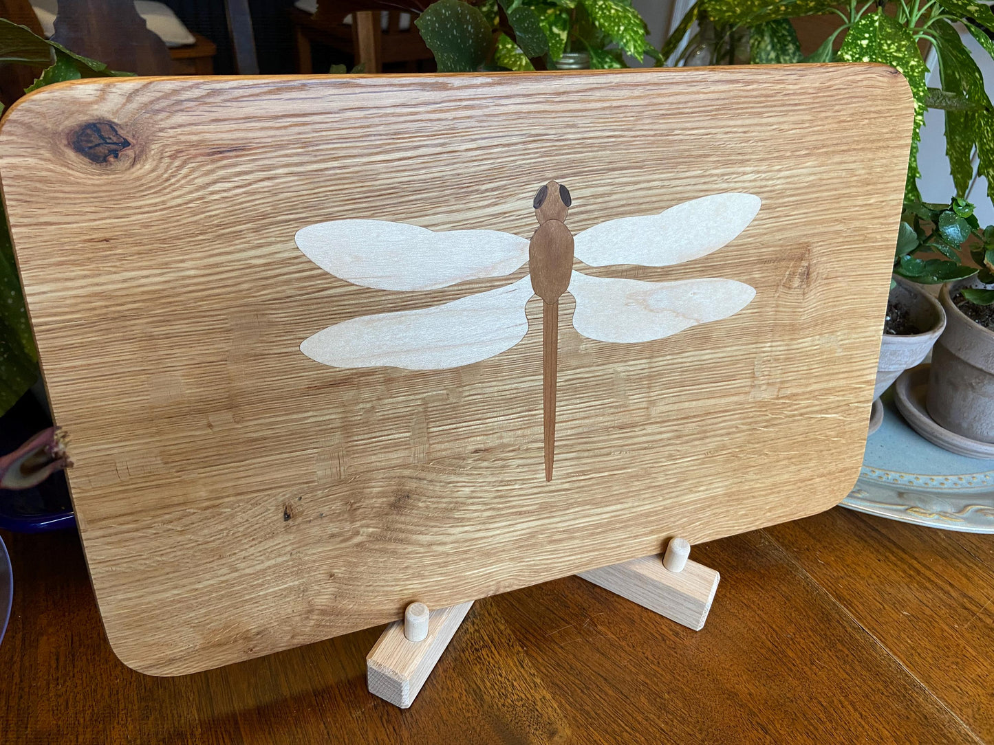 Hand-made art on a wooden canvas.  White Oak charcuterie board; dragonfly inlay of Cherry, Maple and Peruvian Walnut.