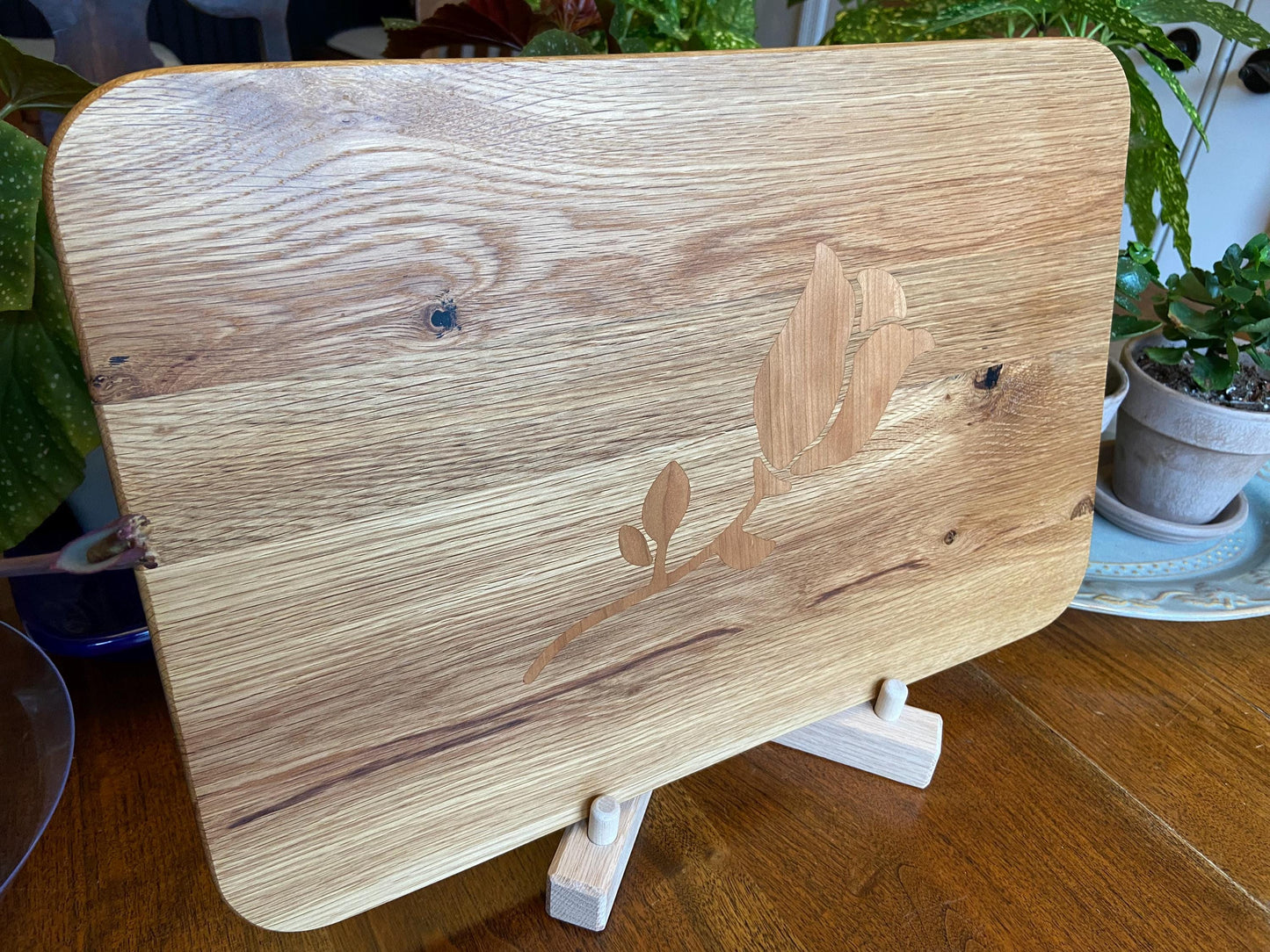 White Oak charcuterie board with subtle rose and stem inlay made from Cherry.
