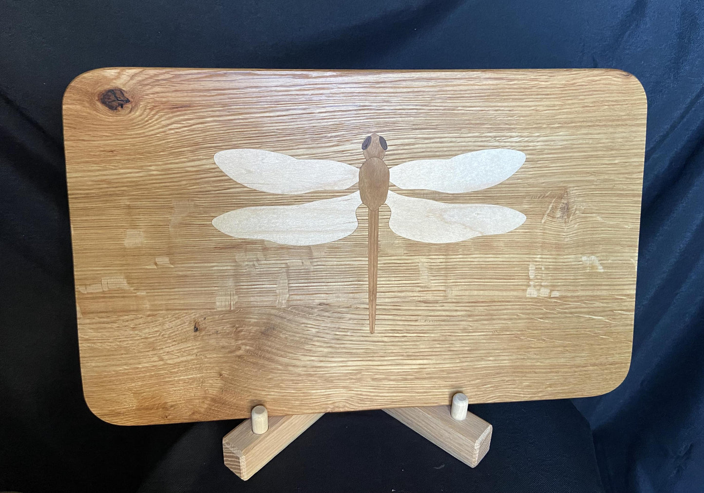 Hand-made art on a wooden canvas.  White Oak charcuterie board; dragonfly inlay of Cherry, Maple and Peruvian Walnut.
