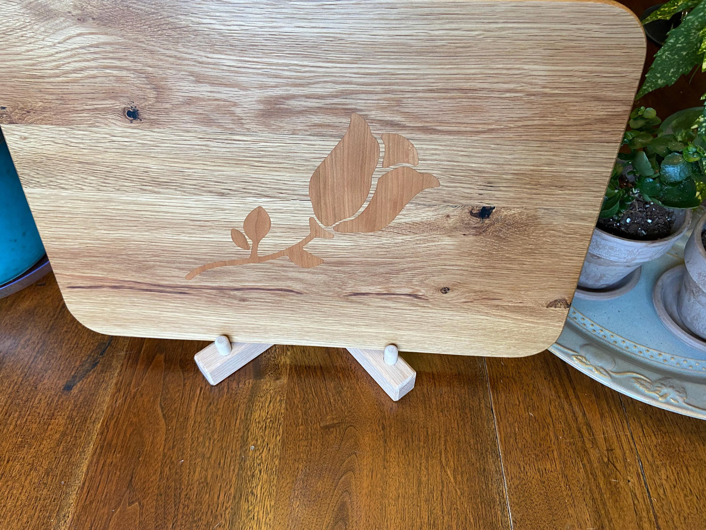 White Oak charcuterie board with subtle rose and stem inlay made from Cherry.