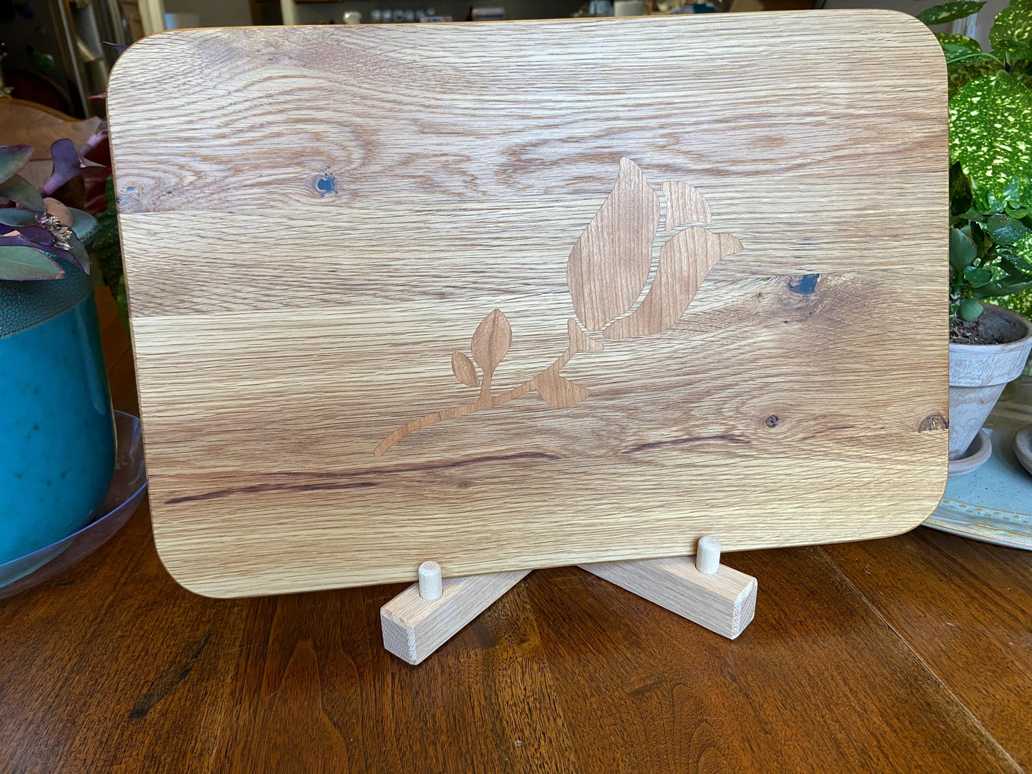 White Oak charcuterie board with subtle rose and stem inlay made from Cherry.