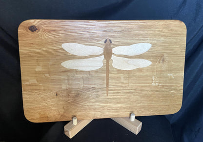 Hand-made art on a wooden canvas.  White Oak charcuterie board; dragonfly inlay of Cherry, Maple and Peruvian Walnut.